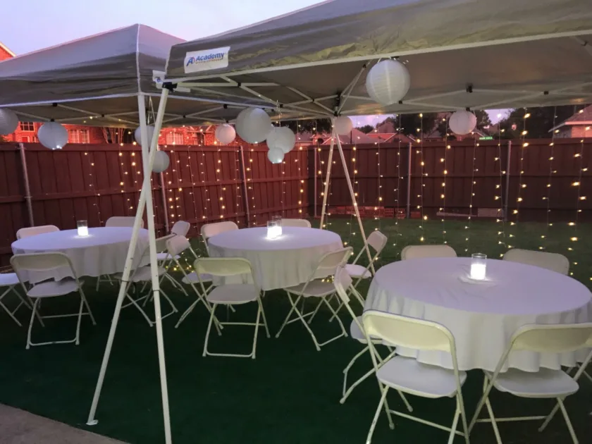 Warm Stringlights Hanging Tent White Tablecloth Grass Angle View Outdoor Lights For Wedding