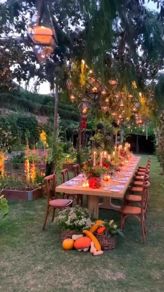 Birthday Party In The Park With Hanging Lamps And Candle Light Centerpiece