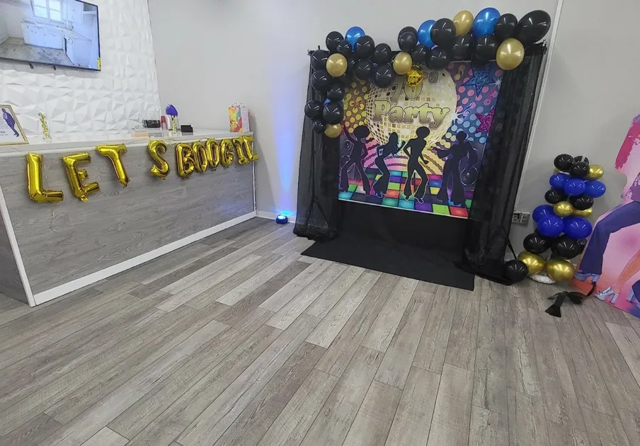 Retro Dance Party Balloon Arch And Poster On Dance Floor